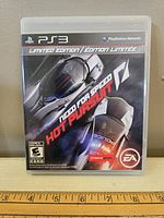 Front cover photo of the PS3 Need For Speed Hot Pursuit game case with visible title, logos, rating, and artwork.
