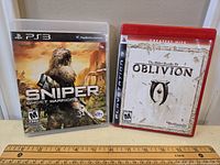 Two PS3 game cases: Sniper Ghost Warrior and The Elder Scrolls IV Oblivion