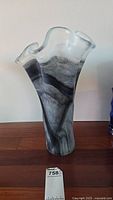 Front view of the tall grey tie-dye glass vase showing wavy open top