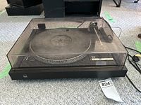 Top view with dust cover on, showing the circular platter and tonearm on the right side. Model label CS505-2 visible.