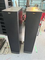 Front view of both Klipsch tower speakers with black grilles