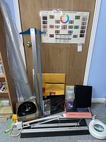 Wide shot of the photo cutting and matting tools including Logan Compact Mat Cutter, ring light, binders, color guide, rulers and plastic wrap