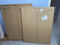 Two large cardboard boxes containing mattes and foam cores