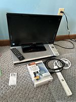 Photo of 19-inch Toshiba TV model 19SL41OU with remote on top of a silver Sony DVD player model RDR-GX330, with accompanying cords and VHS to DVD converter box next to them.