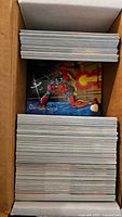 Top-down view of a box full of Marvel trading cards showing thickness and quantity