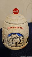 Front view of the Coca-Cola Polar Bear themed ceramic cookie jar with polar bear family artwork and Coca-Cola logo.
