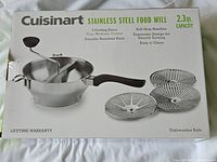 Box showing front with product image and features like 2.3 qt capacity, soft-grip handles, three cutting discs.