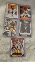 Photo showing five football rookie cards from various brands in mint condition.