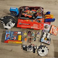 Full lot overview showing all toys including the Bakugan Battle Arena box, Mario set, figurines, masks, and other toys.