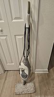 Full view of the Shark LiftAway steam mop with cleaning pad attached, positioned upright on floor.