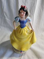 Front view of the vintage Snow White ceramic figurine showing her detailed facial features, dress, and pose.