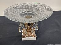 Full view of 1950s ornate pedestal bowl showing cut crystal bowl, hanging prism crystals, ornate metal stem, and marble square base.