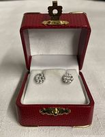 Pair of 925 sterling silver diamond cluster stud earrings in a red jewelry box with white interior.