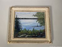 Framed oil painting on board with visible chips and corner wear on the frame