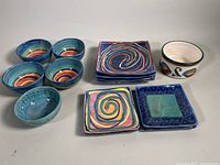 Full view of all pottery dishes and bowls showing colorful swirl and geometric patterns