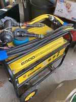 Angle view showing generator head, Champion logo, starting watts label, control panel and attached cable