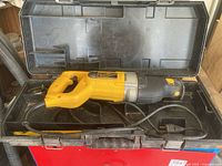 DeWalt DW307M reciprocating saw inside black plastic carrying case.