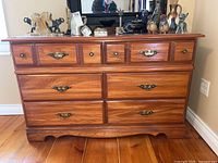 Front full view of the Palliser six drawer dresser showing the wood finish, drawer configuration, and hardware.