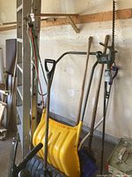 Photo of 12-foot aluminum ladder, snow shovels, garden tools including Black & Decker hedge trimmer and sand shovel