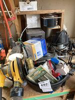 Photo showing Black and Decker router, Sony radio, assorted hardware and parts packed in a container.