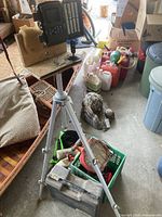 VanTop trail camera mounted on tripod along with dog training toys and various containers scattered around, showing overall contents of the lot.