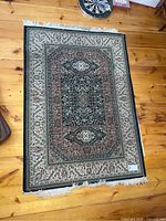 Full view of the 4x6 Turkish carpet showing the traditional pattern, colors, and fringed edges with some missing fringe at corners.