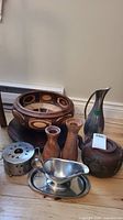 Wide shot of all items showing metal and wooden serveware pieces with distinct designs.