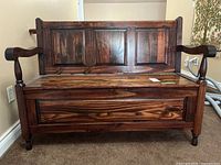 Front view of wooden bench showing three-panel backrest and closed storage seat.