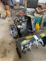 Front view showing auger housing, chute and Yardworks logo