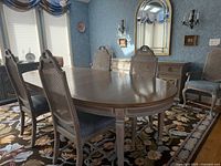 Full dining table, chairs, and buffet in room setting