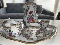 Overview of entire coffee service arranged on scalloped platter.