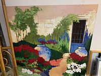 Full front view of square canvas painting leaning against wall