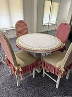 Full view of painted round table and four chairs in room