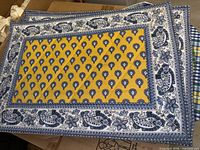 Cotton quilted placemat with blue, yellow, and white floral paisley design, Pierre Deux.