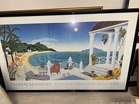 Large framed colorful Thomas McKnight print depicting a tropical porch scene with ocean view at moonlight, with signature and publisher info.