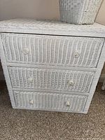 White wicker three-drawer dresser showing woven texture and round wicker knobs