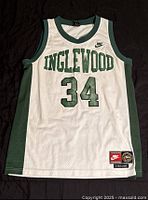 Front view of the Nike Inglewood basketball jersey number 34, size medium, with visible yellowish discoloration on the front lower right section and overall light soiling.
