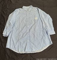 Front view of light blue Ralph Lauren shirt with white polka dots and embroidered logo on chest pocket.