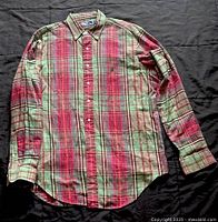 Front view of multi-color plaid Ralph Lauren shirt laid flat on dark background showing full front including buttons and collar.