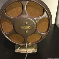 Rear view of the Atwater Kent speaker showing the metal back panel, ventilation holes, and identification plate.