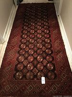 Full view of Bukhara runner rug on floor, showing pattern and size