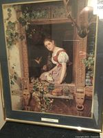 Framed print showing a girl leaning out of a decorated wooden window with ivy around it.