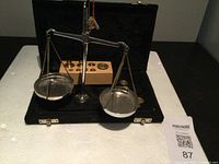 Front-angle view of the jewellers balance scale with pans, weights, and case showing set-up.