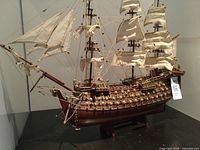 Full starboard side view of the wooden ship model showing three masts, rigging and hull details