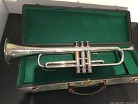 Silver plated trumpet inside green felt-lined black case