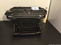 Front view of Underwood antique typewriter, showing keyboard and paper holding roller with Underwood brand logo.