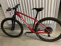 Full side profile of the red Framed mountain bike