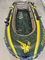Top view of fully inflated green and yellow Intex Seahawk 2 inflatable boat showing interior and exterior details.