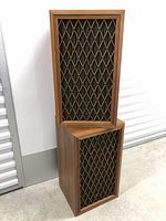 Pair of vintage Pioneer speakers stacked, showing full wood cabinet and lattice grille.