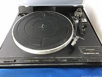 Front angled view of Pioneer PL-670 turntable showing dusty platter, tonearm and control labels.